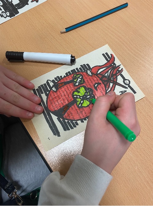 Student working on a Black Out Poetry Design