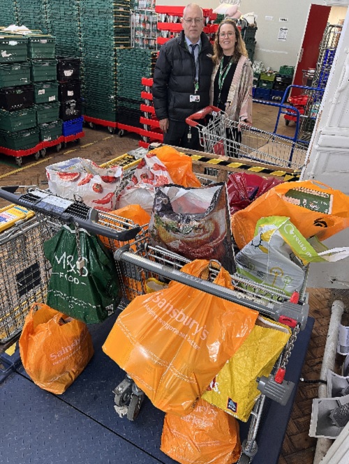 Stock for Lewisham FoodBank Photograph of Abby and Dave DG staff members delivering food stock to Lewisham Foodbank