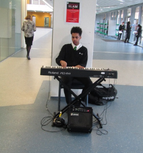 Student greeting parents and students with piano music