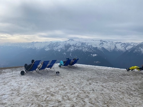 Sunbathers sitting in deckchairs on the ski slopes in Italy